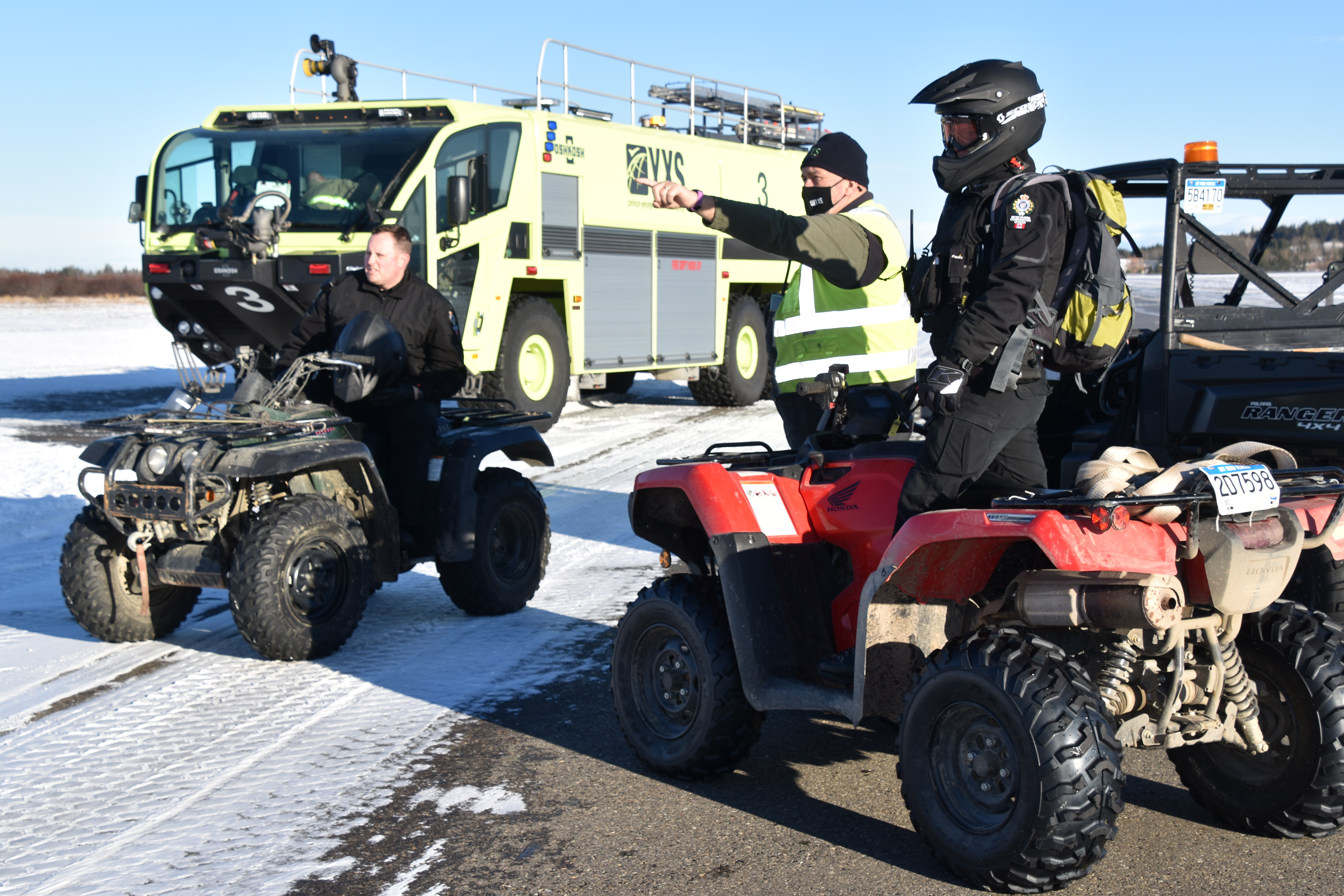 People gather on quads and side-by-sides at the Prince George airport as they prepare to get a moose of the property