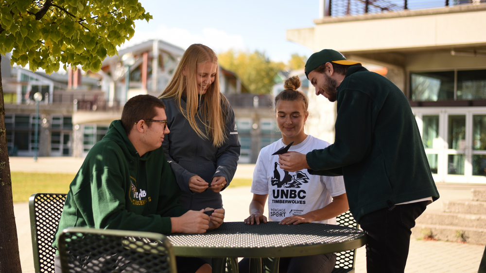 unbc students around a table outside