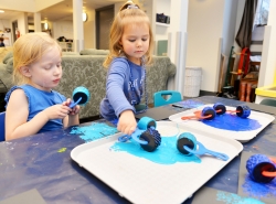 UNBC Childcare girls painting roller