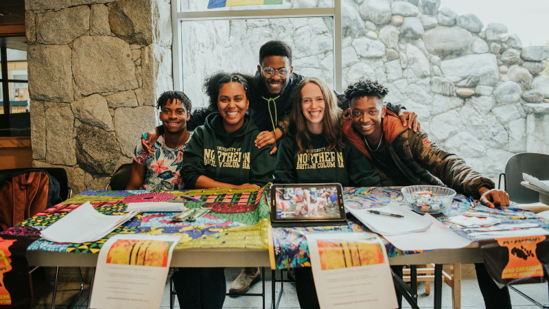UNBC students at a Student-led Club display table