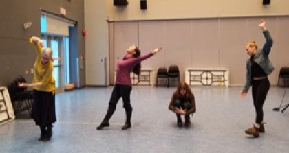four participants in a movement workshop make shapes wit their bodies