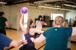 Members participating in a Fit Barre registered class
