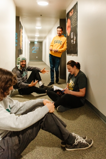 Four students chatting in the hallway