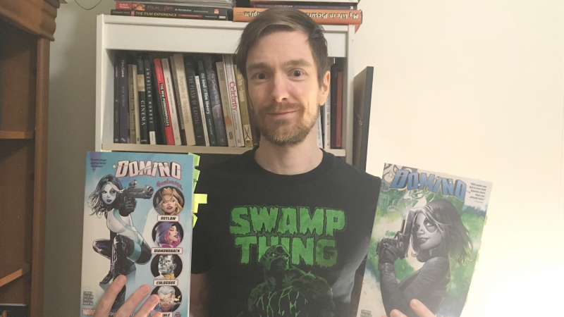 English Assistant Professor Dr. Troy Bordun holding two graphic novels