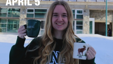 Student ambassador holding coffee mugs