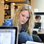Calley Borland studying in the UNBC library. 