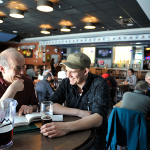Dr. Roger Wheate and student Shane Doddridge catch up in the campus pub, The Thirsty Moose. 