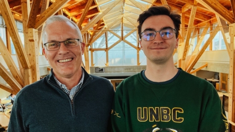 Portrait photo of two people in the Canfor Winter Garden at UNBC, one of Canada's top universities of its size.