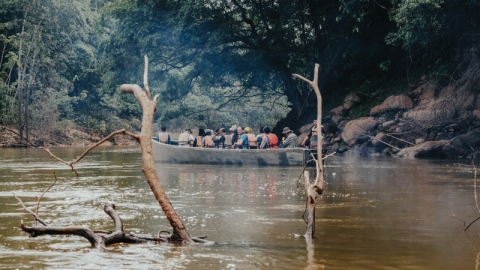 People paddle a canoe on the Amazon, during a field school.